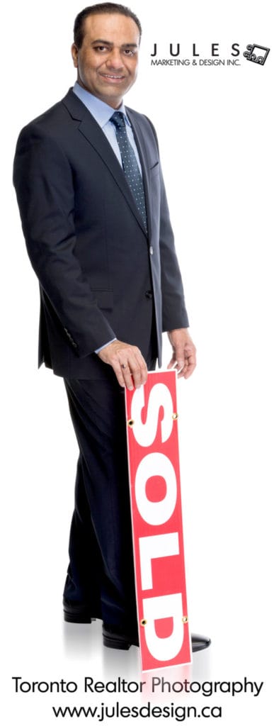 A realtor portrait with real estate sign