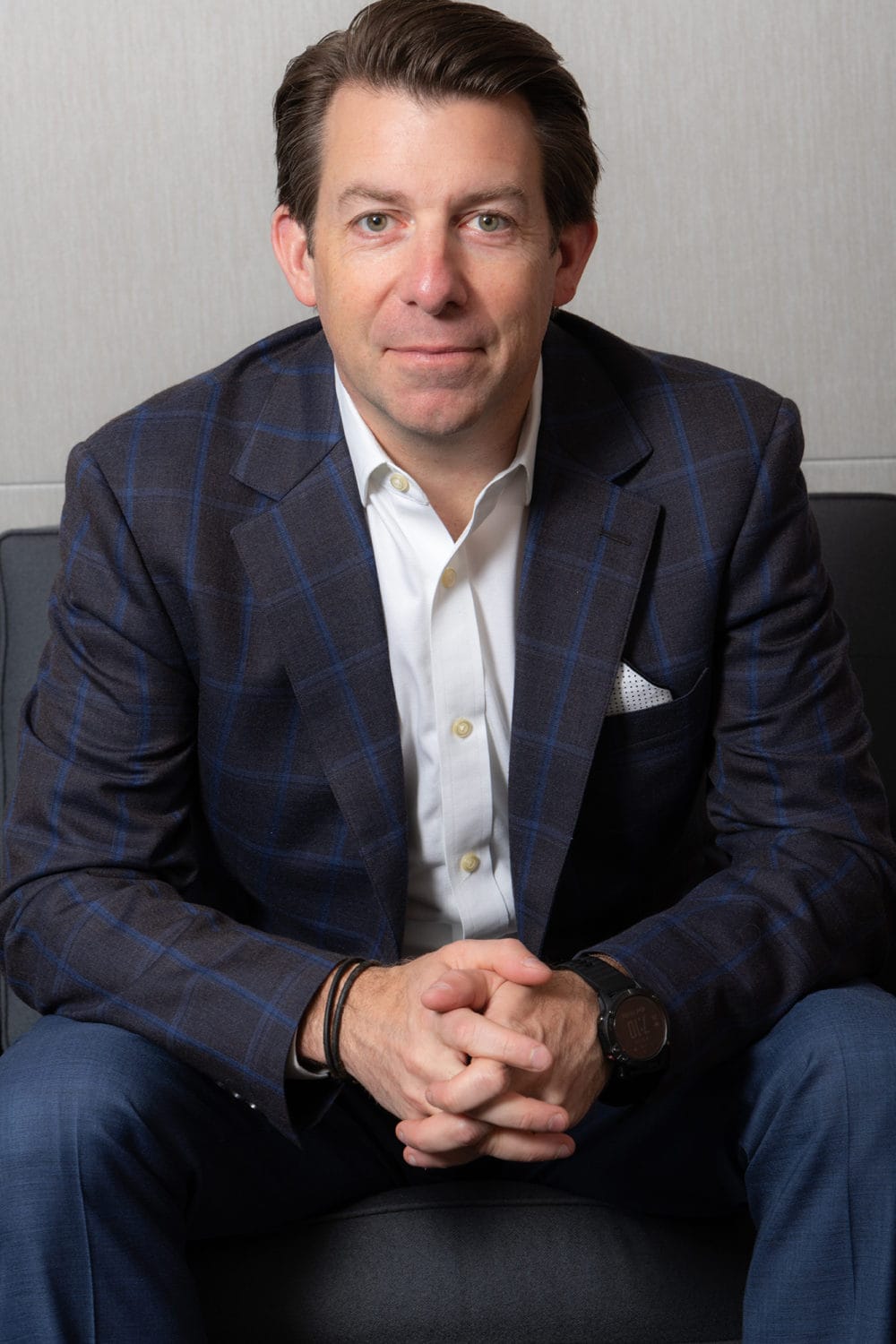 Candid LinkedIn Corporate Photos Photo of a Team member on a colour branded backdrop by Jules Design Toronto Business Headshots